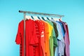 Wardrobe rack with different bright clothes Royalty Free Stock Photo