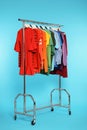 Wardrobe rack with different bright clothes Royalty Free Stock Photo