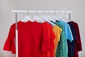 Wardrobe rack with different bright clothes Royalty Free Stock Photo