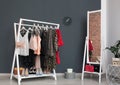 Wardrobe rack with women`s clothes and shoes