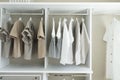 Wardrobe with shirts and pants hanging