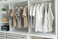 Wardrobe with shirts and pants hanging