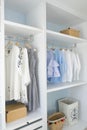 Wardrobe with shirts and pants hanging