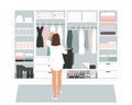 Wardrobe storage room and young elegant woman in front of open closet full of elegant dresses. Everyday choice what to Royalty Free Stock Photo