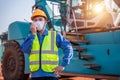 Warehouse asian man worker driver truck driver crane lifting up container with safety equipment, helmet is standing in front of Royalty Free Stock Photo