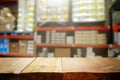 warehouse background, wooden empty table and blurred storage shelfs. Ready for mock up or product display industry Royalty Free Stock Photo