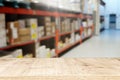 warehouse background, wooden empty table and blurred storage shelfs. Ready for mock up or product display industry Royalty Free Stock Photo