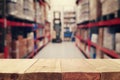 warehouse background, wooden empty table and blurred storage shelfs. Ready for mock up or product display industry Royalty Free Stock Photo