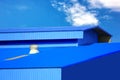 warehouse blue metal sheet roof top against blue sky Royalty Free Stock Photo