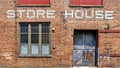 Warehouse brick front background with Store House stenciled above door Royalty Free Stock Photo