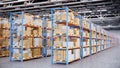 Warehouse with cardboard boxes inside on pallets racks, logistic center. Huge, large modern warehouse. Warehouse filled