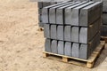 Warehouse of cement pressed materials on wooden pallets. Large pile of grey slabs and curbs for work at construction Royalty Free Stock Photo