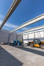 Warehouse construction. Worker on mobile elavating work platform