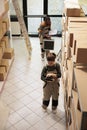 Warehouse employee analyzing products checklist on tablet