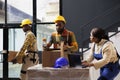 Warehouse employees checking orders on laptop and packing parcels Royalty Free Stock Photo