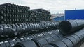 Warehouse of finished plastic pipes industrial outdoors storage site. Manufacture of plastic water pipes factory. Royalty Free Stock Photo