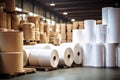 Warehouse for finished products of a paper mill. Large rolls of paper in the workshop. Production of paper and cardboard