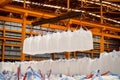 Warehouse handling of starch in jumbo bags. Spread bar lift many jumbo bags at the same time Royalty Free Stock Photo