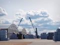 Warehouse hangars of the cargo port, blue cloudy sky, background