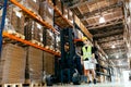 Warehouse worker doing logistics work with forklift loader Royalty Free Stock Photo