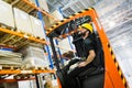 Warehouse worker doing logistics work with forklift loader Royalty Free Stock Photo