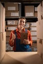 Warehouse inventory manager using digital tablet showing thumbs up gesture while looking at camera Royalty Free Stock Photo