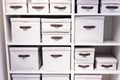 Warehouse loaded with boxes.stack of white textile office boxes. selective focus.Stacks of paperwork placed in