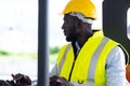 Warehouse man worker driver forklift. warehouse worker driver stacking card boxes by forklift in warehouse store. African American Royalty Free Stock Photo