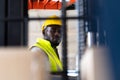 Warehouse man worker driver forklift. warehouse worker driver stacking card boxes by forklift in warehouse store. African American Royalty Free Stock Photo