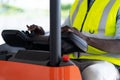 Warehouse man worker driver forklift. warehouse worker driver stacking card boxes by forklift in warehouse store. African American Royalty Free Stock Photo