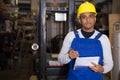 Warehouse manager calculates the quantity of goods and writes it down in notebook