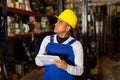 Warehouse manager calculates the quantity of goods and writes it down in notebook