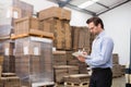 Warehouse manager checking his inventory Royalty Free Stock Photo