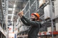 Warehouse manager checking his inventory in a large warehouse Royalty Free Stock Photo