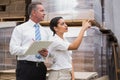 Warehouse manager and her boss checking inventory