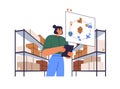 Warehouse manager organizing delivery of goods in boxes. Storehouse worker with tablet PC and packages on shelf. Digital