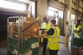 Warehouse manager overseeing the preparation of a delivery