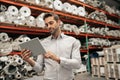 Warehouse manager using a digital tablet while tracing stock Royalty Free Stock Photo