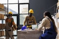 Warehouse managers checking order information on laptop screen