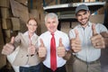 Warehouse managers and delivery driver smiling at camera Royalty Free Stock Photo
