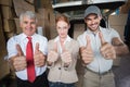 Warehouse managers and delivery driver smiling at camera Royalty Free Stock Photo