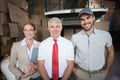 Warehouse managers and delivery driver smiling at camera Royalty Free Stock Photo