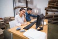 Warehouse managers using telephone and laptop Royalty Free Stock Photo