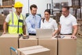 Warehouse managers and worker looking at laptop Royalty Free Stock Photo