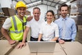 Warehouse managers and worker smiling at camera Royalty Free Stock Photo