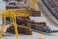 Warehouse of metal products, metal, on the background of a gantry cranes on an industrial site. Metals profiles for