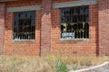 Smashed window panes in an abandoned brick warehouse. Royalty Free Stock Photo