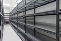 Warehouse racks storage metal pallet racking system in warehouse. Modern interior of new empty warehouse. The shelves are pallet