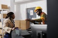 Warehouse reception worker inspecting received cardboard box packing Royalty Free Stock Photo