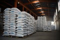 In the warehouse, sacks of chemical fertilizer are stacked, prepared for delivery